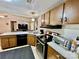 An open kitchen features wood cabinets, black appliances, white countertops, and a view of the open-concept living area at 6401 Alley Rd, Catawba, NC 28609