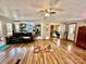 Bright living room shows open floorplan with kitchen, dining, wood floors and neutral paint at 6401 Alley Rd, Catawba, NC 28609