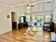 Bright living room with hardwood floors, ceiling fan, and sliding glass doors to the outdoor patio at 6401 Alley Rd, Catawba, NC 28609