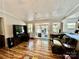 Living room with wood floors, sliding door access to deck, neutral paint and modern entertainment center at 6401 Alley Rd, Catawba, NC 28609
