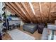 Spacious attic featuring wood beams, storage racks, and an ottoman for potential living space or ample storage at 6726 Park Meadows Pl, Huntersville, NC 28078