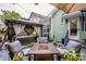 Inviting backyard patio with outdoor seating, fire pit, umbrella, and charming gazebo with curtains at 6726 Park Meadows Pl, Huntersville, NC 28078