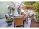 Charming backyard patio with stylish outdoor seating, umbrella, and lush landscaping at 6726 Park Meadows Pl, Huntersville, NC 28078
