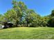 Green backyard with a well-maintained lawn and mature trees, offering a picturesque and spacious outdoor area at 6726 Park Meadows Pl, Huntersville, NC 28078