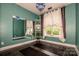 Stylish bedroom with green walls, large mirrors, wood floors, and ample natural light from the large windows at 6726 Park Meadows Pl, Huntersville, NC 28078