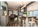 Open-concept dining area features a rustic wood table, decorative lighting, and seamless flow to the living space at 6726 Park Meadows Pl, Huntersville, NC 28078