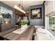 Dining area with bench seating, a modern chandelier, and artwork on display at 6726 Park Meadows Pl, Huntersville, NC 28078