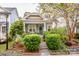 Charming home with lush landscaping and a welcoming front porch with dark green door and symmetrical shrubbery at 6726 Park Meadows Pl, Huntersville, NC 28078