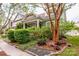 Charming cottage with lush landscaping, brick retaining wall and mature tree in the front yard at 6726 Park Meadows Pl, Huntersville, NC 28078