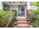 Inviting front porch with potted plants, brick stairs, and charming decor surrounding the front door at 6726 Park Meadows Pl, Huntersville, NC 28078