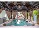 Luxurious hot tub with gazebo, chandelier, lights, and outdoor furniture at 6726 Park Meadows Pl, Huntersville, NC 28078