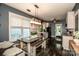 Open kitchen with modern light fixtures, dining table with bench seating and white cabinetry at 6726 Park Meadows Pl, Huntersville, NC 28078