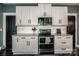 Modern kitchen featuring sleek white cabinets, granite countertops, and stainless steel appliances at 6726 Park Meadows Pl, Huntersville, NC 28078