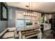 Dining area with natural light, bench seating, modern light fixture, white cabinets and stainless steel appliances at 6726 Park Meadows Pl, Huntersville, NC 28078
