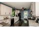 Well-lit kitchen with white cabinetry, stainless appliances, granite countertops, and greenery by the window at 6726 Park Meadows Pl, Huntersville, NC 28078