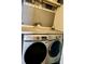 Well-lit laundry room featuring a modern Samsung washer and Whirlpool dryer for efficient cleaning at 6726 Park Meadows Pl, Huntersville, NC 28078
