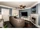 Comfortable living room with dark wood floors, a cozy sofa, fireplace, and a large screen television at 6726 Park Meadows Pl, Huntersville, NC 28078