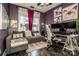 Functional office space with a gray sectional, butterfly art, and a dual monitor setup for productivity at 6726 Park Meadows Pl, Huntersville, NC 28078
