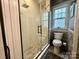 Modern bathroom with a glass-enclosed shower, tile flooring, and a stylish gray and white color scheme at 6726 Park Meadows Pl, Huntersville, NC 28078