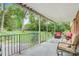 Relaxing back porch overlooking a lush, green backyard with mature trees and comfortable seating at 722 12Th Nw Ave, Hickory, NC 28601