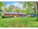 Expansive backyard featuring a brick home, manicured lawn, a shed, and outdoor seating area at 722 12Th Nw Ave, Hickory, NC 28601