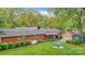 Lush backyard with well-maintained lawn, a cozy seating area, storage shed and mature trees at 722 12Th Nw Ave, Hickory, NC 28601