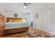 Bedroom showcasing wood floors, ceiling fan, access to a bathroom, and white trim at 722 12Th Nw Ave, Hickory, NC 28601