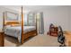 Comfortable bedroom with four-poster bed, carpet, and a bookshelf at 722 12Th Nw Ave, Hickory, NC 28601