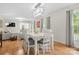 Bright dining room features a white table and chairs, hardwood floors, and modern light fixture at 722 12Th Nw Ave, Hickory, NC 28601
