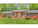 Charming brick home with a welcoming front porch and rocking chairs at 722 12Th Nw Ave, Hickory, NC 28601