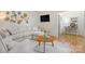 Bright living room featuring hardwood floors, a cozy sectional, and a decorative plate collection at 722 12Th Nw Ave, Hickory, NC 28601