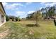 View of backyard showing lawn, trees, and fence line at 8011 Green Heron Ct, Belmont, NC 28012