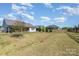 Expansive backyard with lawn, trees, and fence line at 8011 Green Heron Ct, Belmont, NC 28012