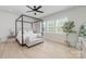Bright bedroom with large windows, a ceiling fan, and a stylish four-poster bed at 8011 Green Heron Ct, Belmont, NC 28012