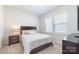 Cozy bedroom with a comfortable bed, nightstand, and bright window at 8011 Green Heron Ct, Belmont, NC 28012