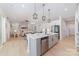 Spacious kitchen with an island, stainless steel appliances, and a seamless transition to the living room with open layout at 8011 Green Heron Ct, Belmont, NC 28012