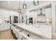 Modern kitchen with stainless appliances, white countertops, and a large center island with barstool seating at 8011 Green Heron Ct, Belmont, NC 28012