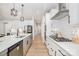 This modern kitchen boasts stainless steel appliances, sleek white cabinets, and a spacious island with sink at 8011 Green Heron Ct, Belmont, NC 28012