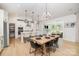 Bright, open kitchen/dining area with large island, pendant lights, and seamless flow to outdoor living space at 8011 Green Heron Ct, Belmont, NC 28012
