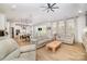 Open concept living area featuring a kitchen, dining space, and sitting area with large windows and hardwood floors at 8011 Green Heron Ct, Belmont, NC 28012