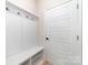 Mudroom with coat rack and bench and additional shoe storage at 8011 Green Heron Ct, Belmont, NC 28012