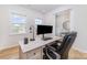 Bright home office with natural light, a modern desk, and wood-look flooring at 8011 Green Heron Ct, Belmont, NC 28012
