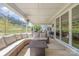 Covered patio features outdoor sectional, propane heater, and grill; backyard views at 8011 Green Heron Ct, Belmont, NC 28012
