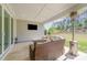 Covered patio with outdoor seating area and expansive views of backyard and trees at 8011 Green Heron Ct, Belmont, NC 28012