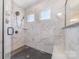 This frameless glass shower features beautiful tile and a rainfall shower head at 8011 Green Heron Ct, Belmont, NC 28012