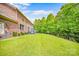 Expansive backyard featuring a lush green lawn, mature trees, and an outdoor deck at 8169 Clems Branch Rd, Indian Land, SC 29707