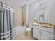 Bathroom with tub/shower combo, granite countertop, and well-lit vanity at 8169 Clems Branch Rd, Indian Land, SC 29707