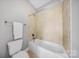 Cozy bathroom featuring a tub with tile surround, neutral walls, and modern fixtures at 8169 Clems Branch Rd, Indian Land, SC 29707