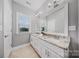 Elegant bathroom features double sinks with granite countertops and a large mirror at 8169 Clems Branch Rd, Indian Land, SC 29707
