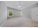 Upstairs bedroom with carpet, ceiling fan, and large windows offering natural light at 8169 Clems Branch Rd, Indian Land, SC 29707
